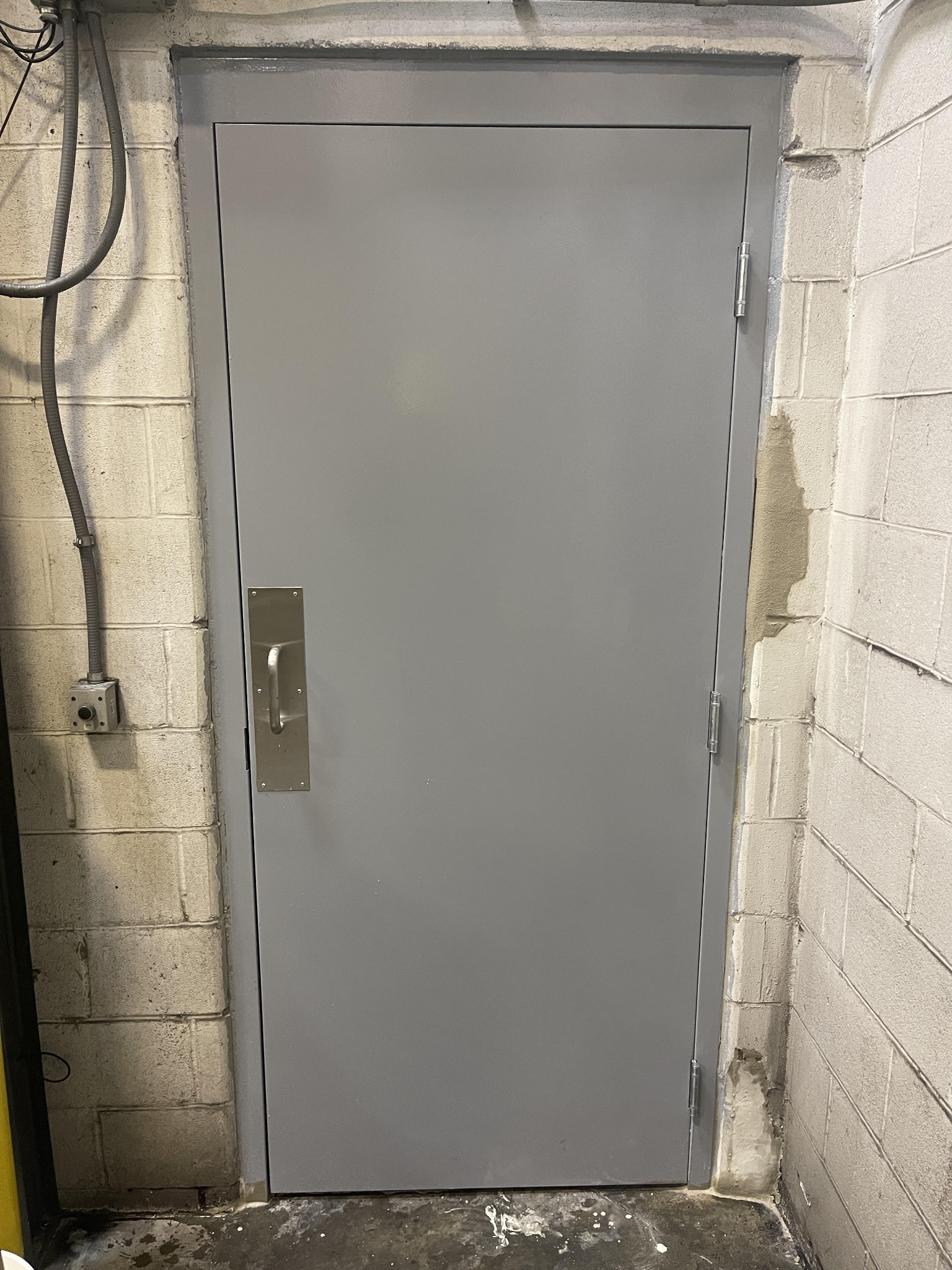 Commercial metal door and frame installed in a masonry wall