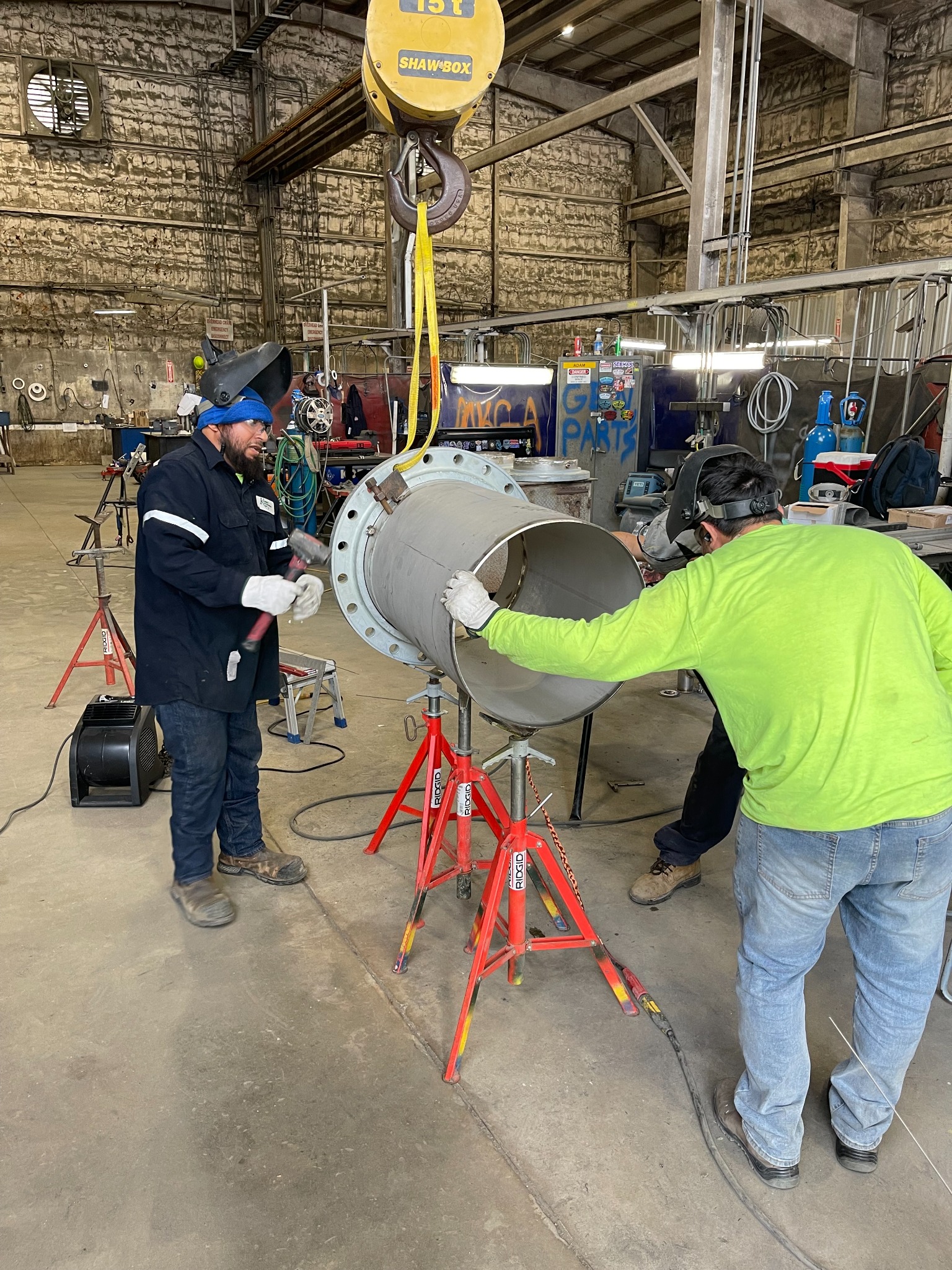 Kerby craft professionals working together on a pipe assembly