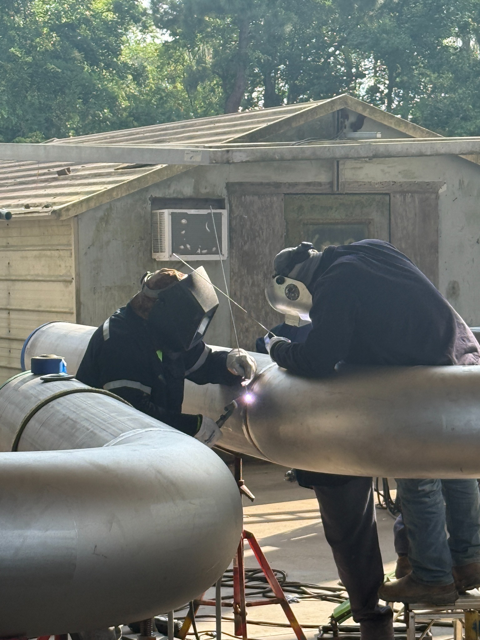 Craft professionals welding industrial piping